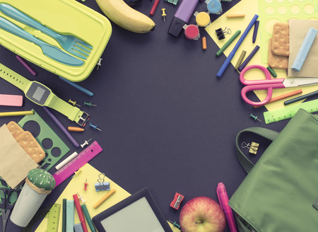 Concept back to school apple backpack stationery on black background top view flat lay