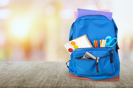 School bag on wooden background