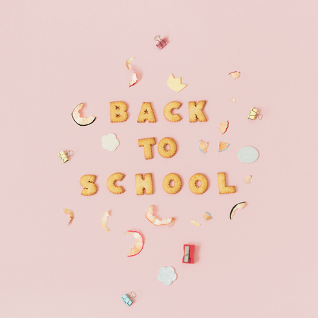 Colorful background with lettering back to school made of cookies on pink pastel background school concept Stock Photo