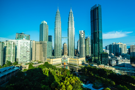 Beautiful architecture building exterior city in kuala lumpur skyline with white cloud and blue sky