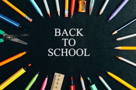 A school supplies on blackboard back to school