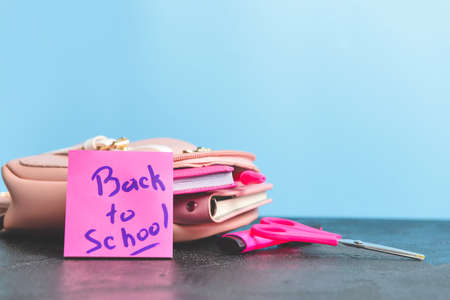 Set of school supplies on table against color background Stock Photo