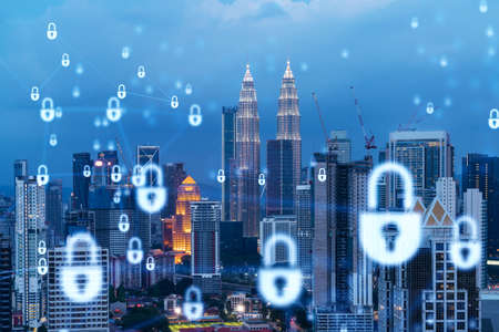 Glowing padlock hologram night panoramic city view of kuala lumpur malaysia asia the concept of cyber security shields to protect kl companies double exposure Stock Photo