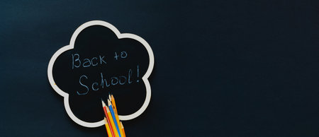 Back to school over chalkboard background school supplies on dark background creative copy space for seasonal projects and basis designs