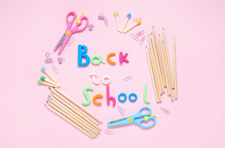 Text back to school and stationery on pink background