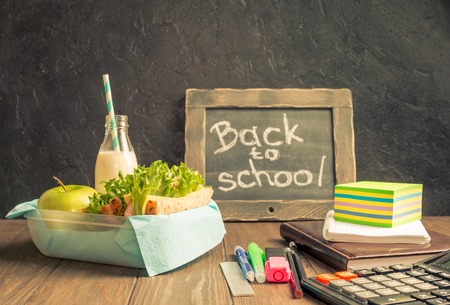 School lunch with sandwich milk and apple on dark background Stock Photo