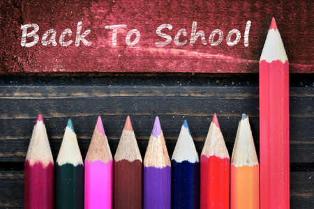 Back to school text and group of pencil on wooden table