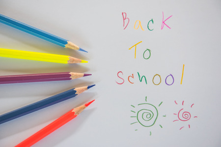 â€œ back to school â€written on white paper and crayon Stock Photo