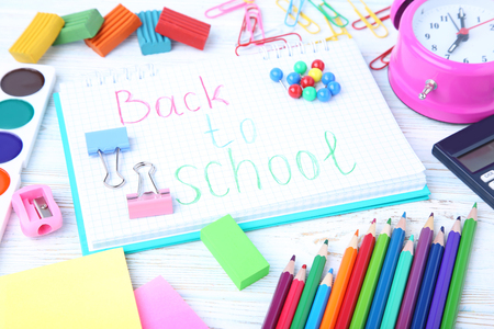 Inscription back to school with stationery on wooden table