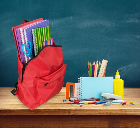 Back to school concept photo of items for school student gear and autumn maple leaves isolated on white background